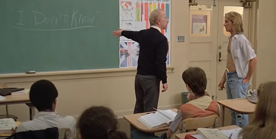 Two men in front of a classroom chalkboard